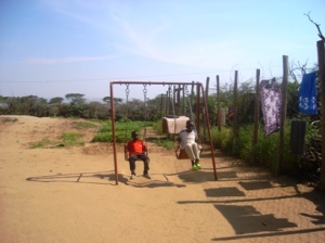 Children play on a swing in a JRS care centre
